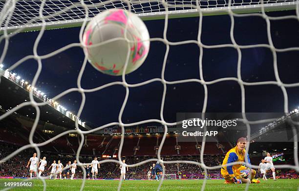 Canada's goalkeeper Erin Mcleod turns to see the ball in the net from US forward Abby Wambach penalty during the London 2012 Olympic Games women's...