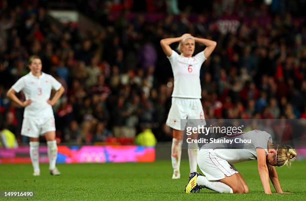 Diana Matheson of Canada in dejection with her team-mates after the final whistle during the Women's Football Semi Final match between Canada and...