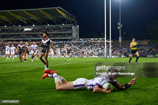 Will Warbrick of the Storm scores a try during the round 16 NRL match between Wests Tigers and Melbourne Storm at Campbelltown Stadium on June 17,...