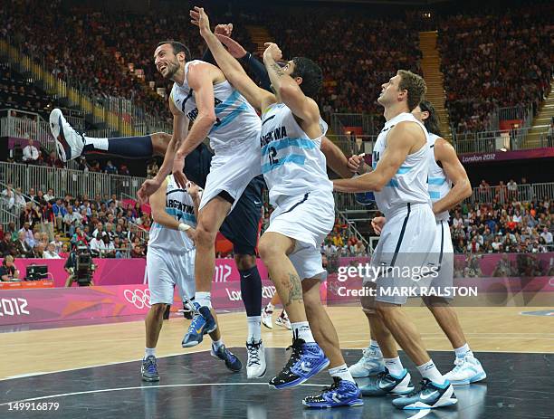 Argentinian centre Martin Leiva and teammates jump foir the ball during the men's basketball preliminary round match Argentina vs USA as part of the...