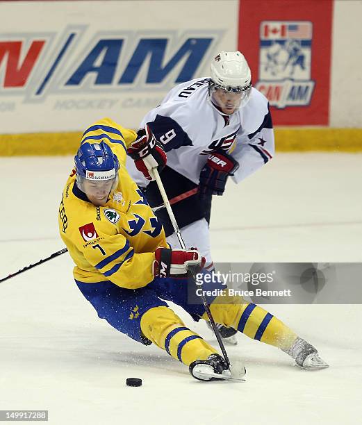 Cole Bardreau of the USA White Squad takes a third period penalty for tripping Tom Nilsson of Team Sweden at the USA hockey junior evaluation camp at...