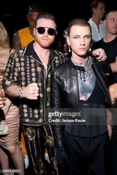 Saul Canelo Alvarez and Machine Gun Kelly are seen front row at the Dolce&Gabbana Spring/Summer 2024 fashion show during the Milan Fashion Week...