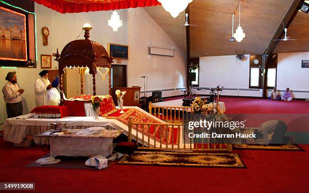 Members of the Sikh community along with other mourners attend a special service at the Sikh Religious Society of Wisconsin for the victims of the...