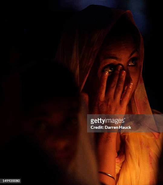 Member of the Sikh community attends a candle light vigil at the Sikh Religious Society of Wisconsin for the victims of the shooting at the Sikh...