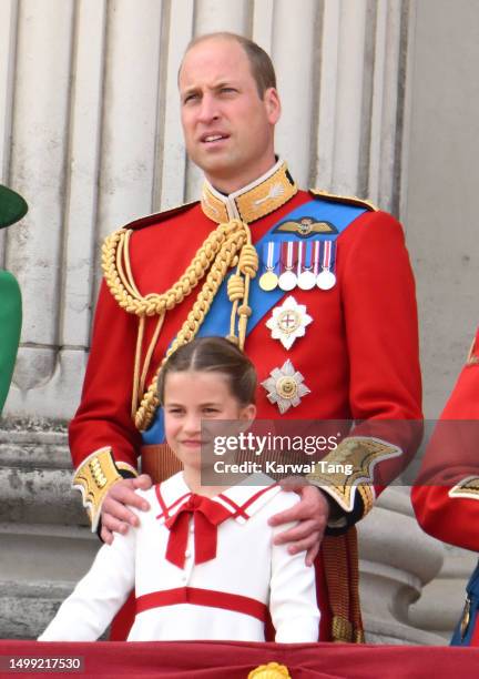 Princess Charlotte of Wales and Prince William, Prince of Wales stand on the balcony of Buckingham Palace to watch a fly-past of aircraft by the...