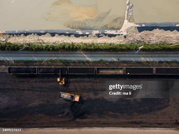 truck loading and unloading at coal yard - metal ore stock pictures, royalty-free photos & images