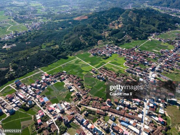 a bird's-eye view of an idyllic village and fields - 全景 stock pictures, royalty-free photos & images