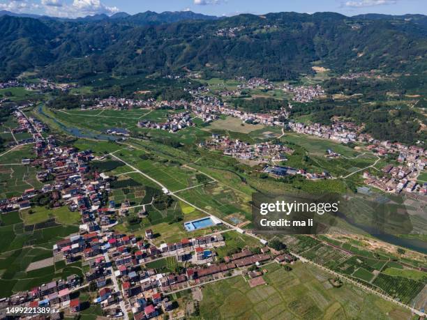 an aerial view of an idyllic village and hills - 全景 stock pictures, royalty-free photos & images