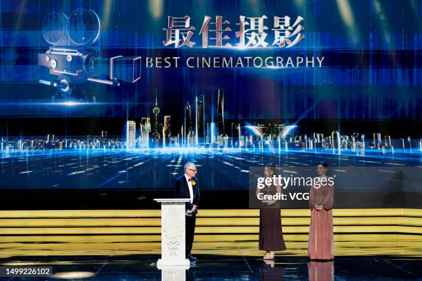 Director Marta Lallana receives her Best Cinematography trophy from German director of photography Lutz Reitemeier and Chinese actress MeI Ting on...