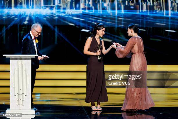 Director Marta Lallana receives her Best Cinematography trophy from German director of photography Lutz Reitemeier and Chinese actress MeI Ting on...