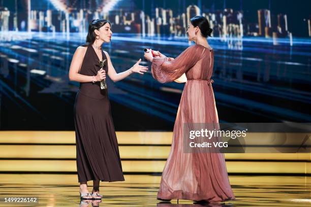 Director Marta Lallana receives her Best Cinematography trophy from actress Mei Ting on the stage during the closing ceremony of the 25th Shanghai...