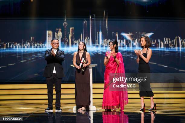 Director Marta Lallana receives her Jury Grand Prix trophy from Indian director and actress Nandita Das , Indonesian director Garin Nugroho and...