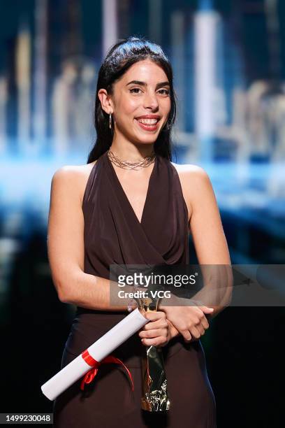 Director Marta Lallana poses with her Jury Grand Prix trophy on the stage during the closing ceremony of the 25th Shanghai International Film...