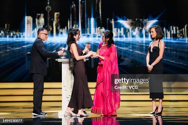 Director Marta Lallana receives her Jury Grand Prix trophy from Indian director and actress Nandita Das , Indonesian director Garin Nugroho and...