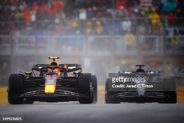 Sergio Perez of Mexico driving the Oracle Red Bull Racing RB19 leads George Russell of Great Britain driving the Mercedes AMG Petronas F1 Team W14...