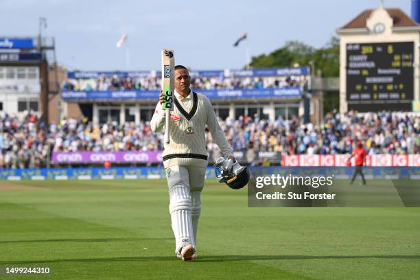 Usman Khawaja of Australia raises his bat as he leaves the field at the end of play during Day 2 of the LV= Insurance Ashes 1st Test match between...