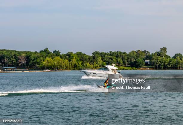 boat and jetski on table rock lake - branson missouri stock pictures, royalty-free photos & images