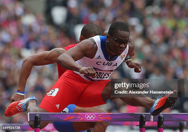 Dayron Robles of Cuba leads Hector Cotto of Puerto Rico in the Men's 110m Hurdles Round 1 Heats on Day 11 of the London 2012 Olympic Games at Olympic...