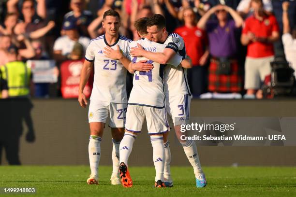 Andrew Robertson of Scotland embraces teammate Billy Gilmour after the team's victory in the UEFA EURO 2024 qualifying round group A match between...