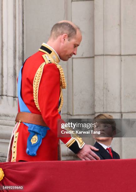 Prince William, Prince of Wales and Prince Louis of Wales stand on the balcony of Buckingham Palace to watch a fly-past of aircraft by the Royal Air...