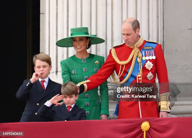 Prince George of Wales, Prince Louis of Wales, Catherine, Princess of Wales and Prince William, Prince of Wales stand on the balcony of Buckingham...