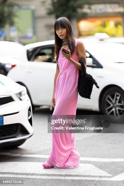 Guest is seen wearing a pink long dress outside Emporio Armani show during the Milan Fashion Week - Menswear Spring/Summer 2024 on June 17, 2023 in...