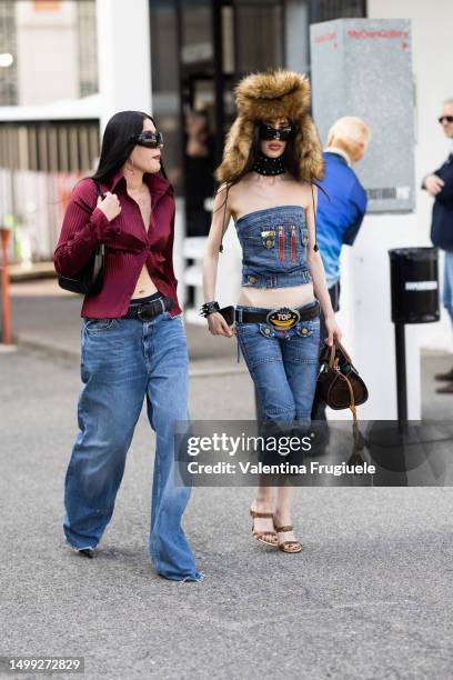 Guests are seen wearing a purple button shirt, a strapless denim top, under the knee denim pants and busby fur hat outside Jordanluca show during the...