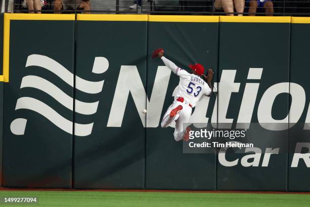 Adolis Garcia of the Texas Rangers cannot catch a ball hit by Bo Bichette of the Toronto Blue Jays in the first inning at Globe Life Field on June...