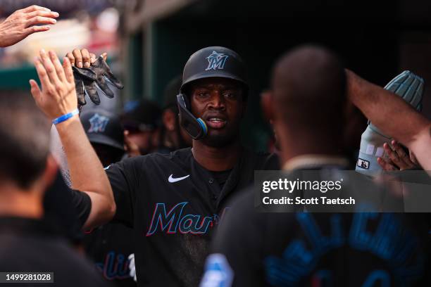 Jesus Sanchez of the Miami Marlins celebrates with teammates in the dugout after scoring a run during the second inning against the Washington...