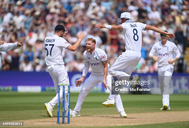 England bowler Ben Stokes celebrates the wicket of Steve Smith, after review, with team mates Ollie Robinson and Stuart Broad during day two of the...