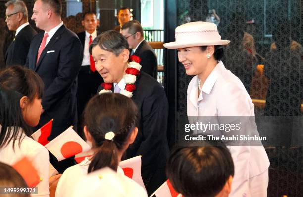 Emperor Naruhito and Empress Masako talk with children on arrival at their hotel on June 17, 2023 in Jakarta, Indonesia.