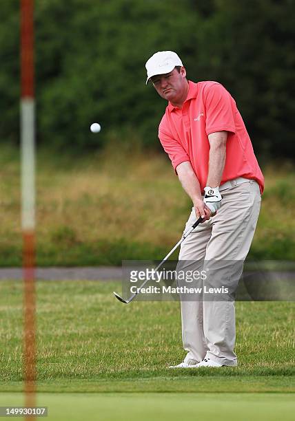 John Dwyer of Ashbourne Golf Club chips onto the 11th green during day one of the Glenmuir PGA Professional Championship at Carden Park Golf Club on...