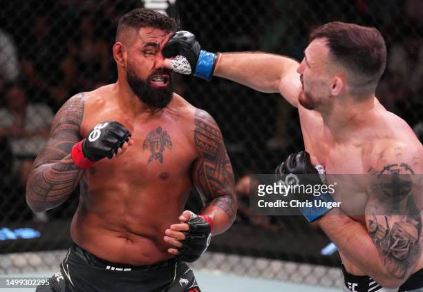 Modestas Bukauskas of Lithuania punches Zac Pauga in a light heavyweight fight during the UFC Fight Night event at UFC APEX on June 17, 2023 in Las...