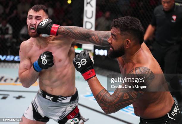 Zac Pauga punches Modestas Bukauskas of Lithuania in a light heavyweight fight during the UFC Fight Night event at UFC APEX on June 17, 2023 in Las...