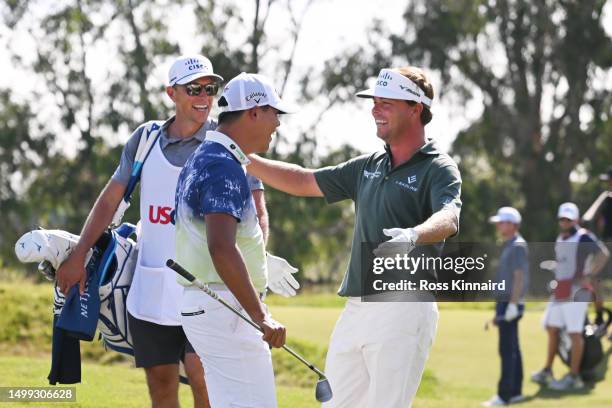 Si Woo Kim of South Korea and Keith Mitchell of the United States greet each other on the 15th tee during the third round of the 123rd U.S. Open...