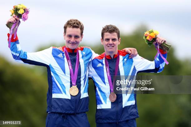 Alistair Brownlee of Great Britain poses with his gold medal next to his brother and bronze medalist Jonathan Brownlee of Great Britain during the...