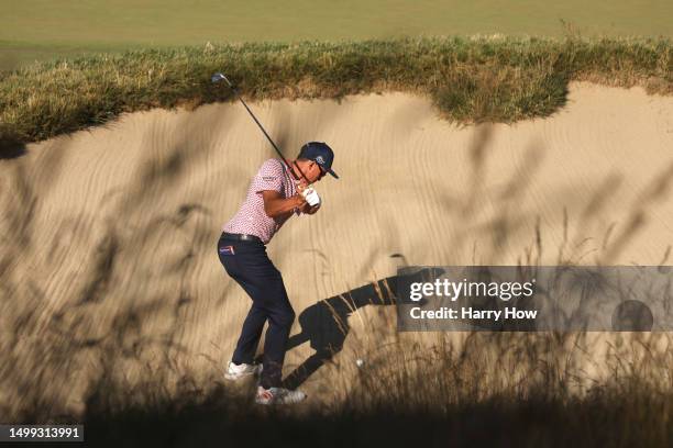 Rickie Fowler of the United States plays a shot from a bunker on the eighth hole during the third round of the 123rd U.S. Open Championship at The...