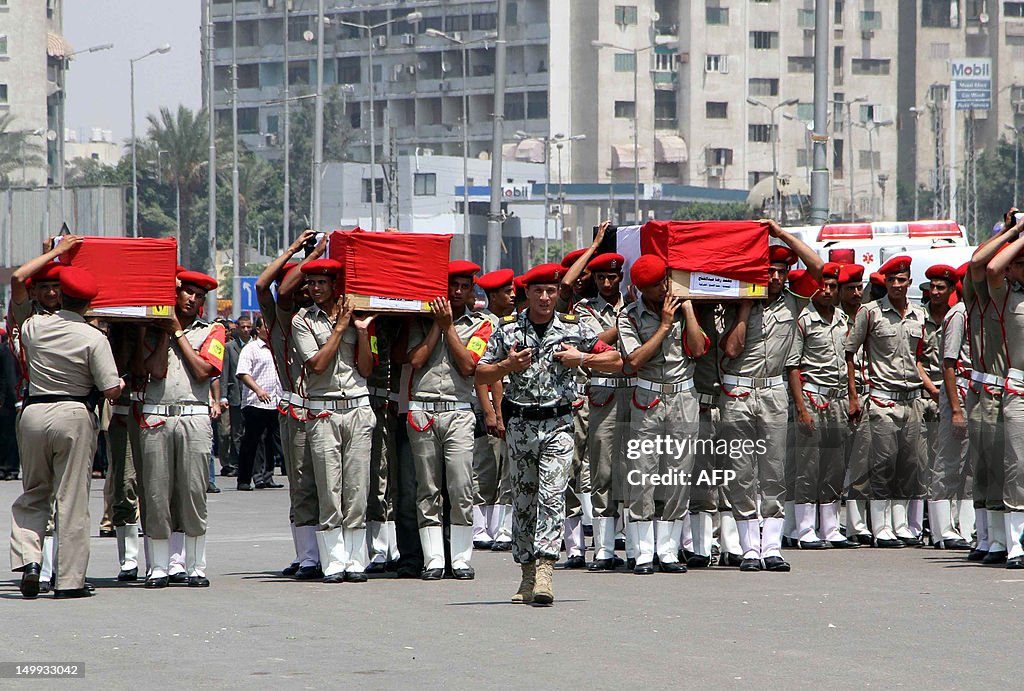 Egyptian military policemen carry the co