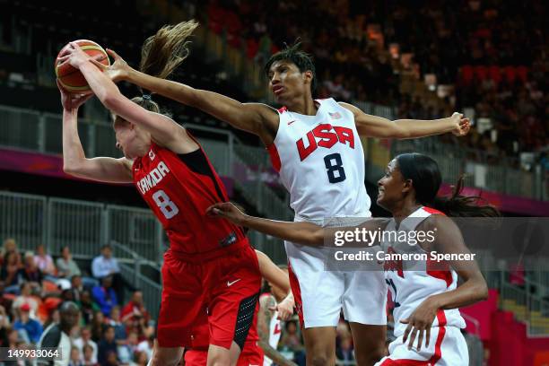 Kim Smith of Canada and Angel McCoughtry of the United States contest the ball during the Women's Basketball quaterfinal between Canada and the...