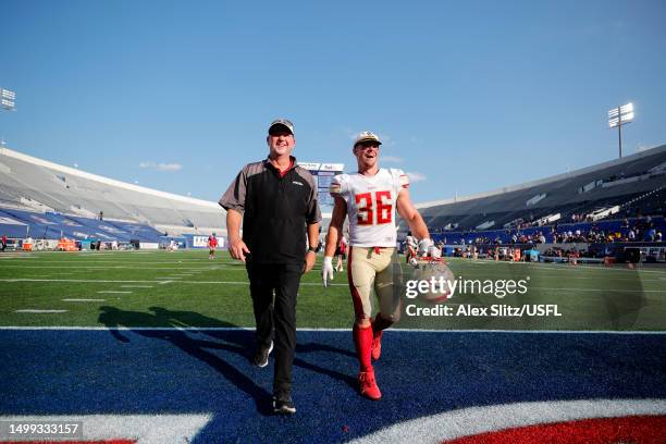 Head coach Skip Holtz of the Birmingham Stallions jokes with Nate Holley of the Birmingham Stallions as they walk off the field after a 27-20 win...