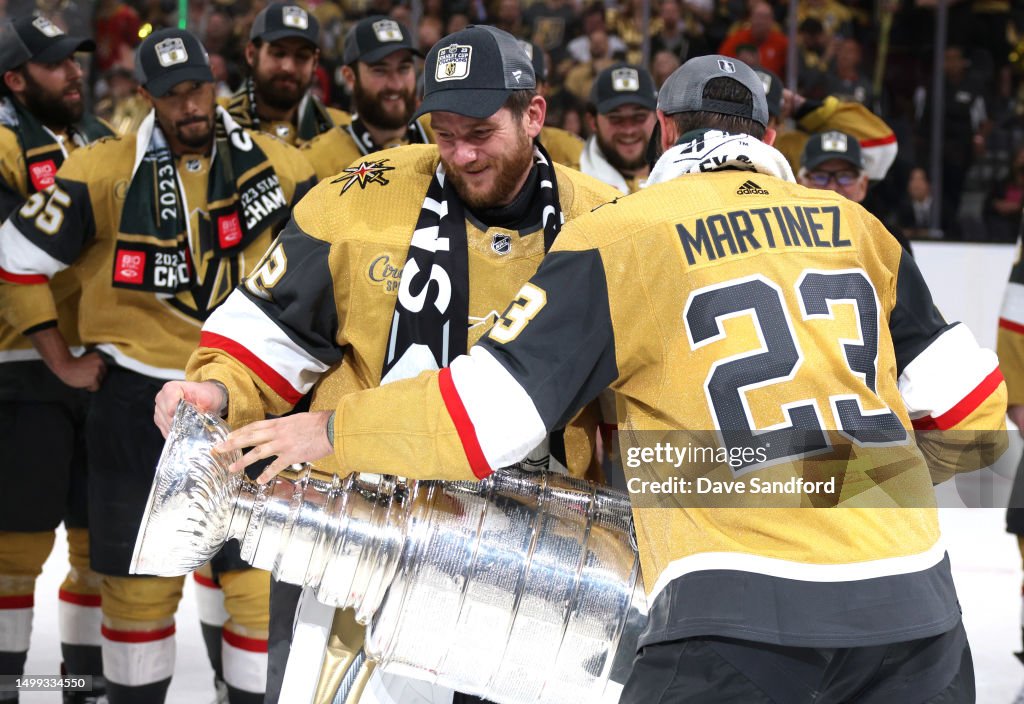 Alec Martinez of the Vegas Golden Knights hands the Stanley Cup to