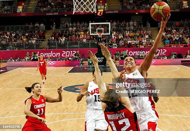 Diana Taurasi shoots over Canada's Lizanne Murphy during the women's quarter final basketball match USA vs Canada at the London 2012 Olympic Games on...