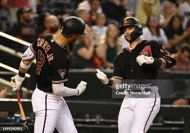 Christian Walker of the Arizona Diamondbacks celebrates with Lourdes Gurriel Jr after hitting a two run home run against the Cleveland Guardians...
