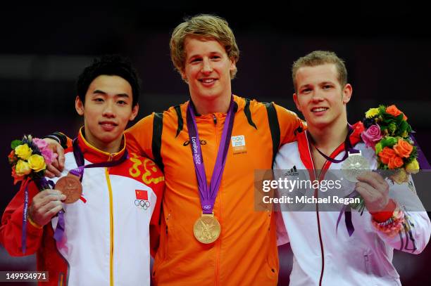 Bronze medalist Kai Zou of China, gold medalist Epke Zonderland of Netherlands and silver medalist Fabian Hambuchen of Germany pose on the podium...