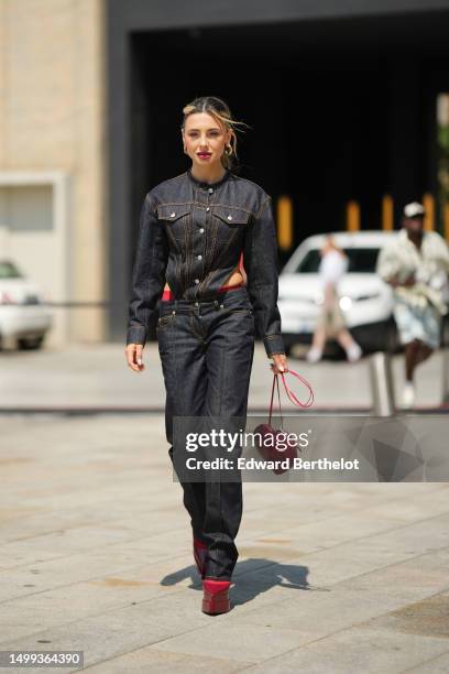 Guest wears gold earrings, a navy blue denim with camel embroidered seams pattern / cut-out corset waist / buttoned shirt jacket, matching navy blue...