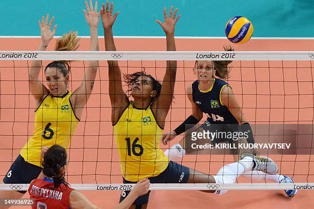 Russia's Nataliya Goncharova spikes as Brazil's Thaisa Menezes and Fernanda Rodrigues attempt to block during the Women's quarterfinal volleyball...