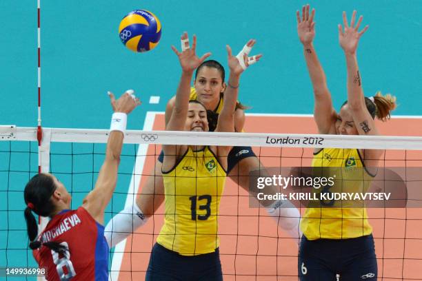 Russia's Nataliya Goncharova spikes as Brazil's Thaisa Menezes and Sheilla Castro attempt to block during the Women's quarterfinal volleyball match...