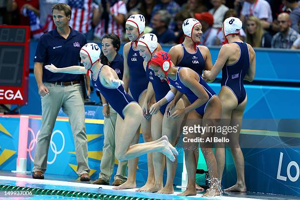 Kelly Rulon of the United States jumps in the water as she celebrates with her teammatesafter they won 11-9 against Australia during the Women's...