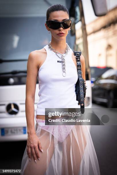 Guest, is seen wearing a white tank top, transparent skirt and black sunglasses outside MSGM during the Milan Fashion Week - Menswear Spring/Summer...