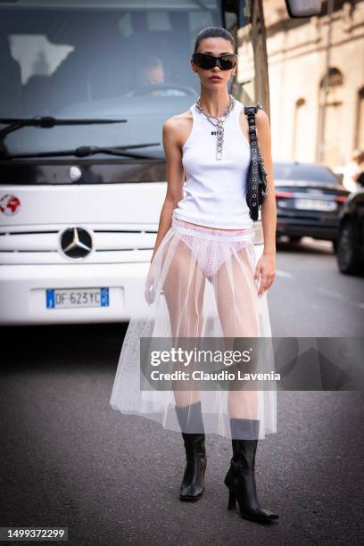 Guest, is seen wearing a white tank top, transparent skirt and black sunglasses outside MSGM during the Milan Fashion Week - Menswear Spring/Summer...